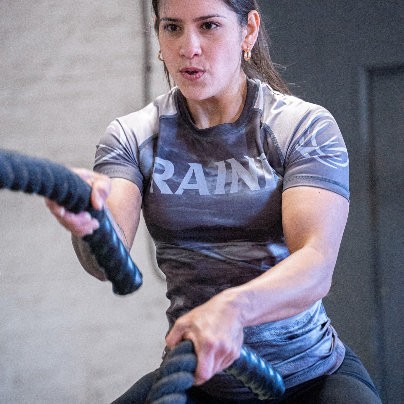 a woman training in a gym wearing raine clothing