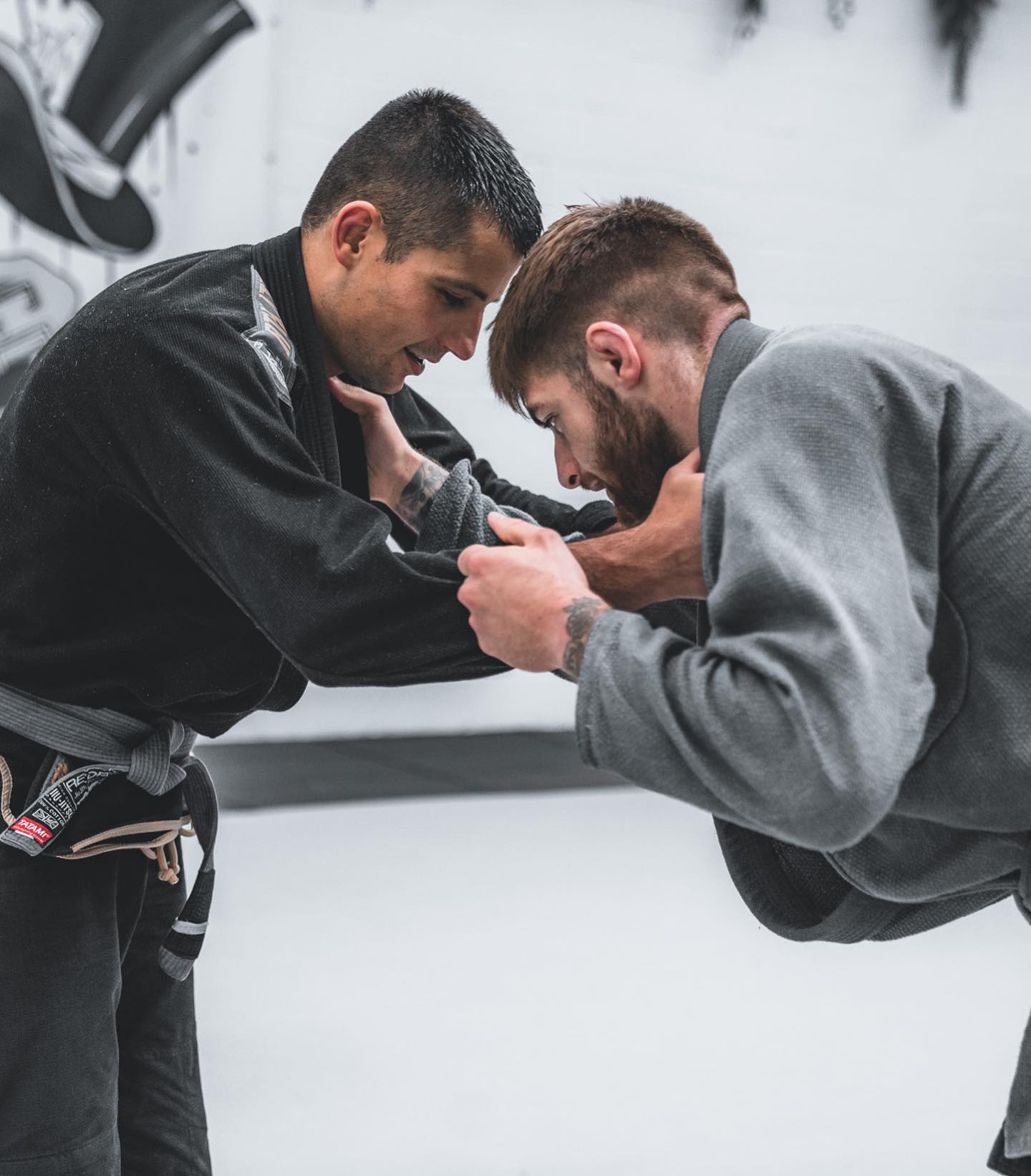 two jiu jitsu athletes performing in gi