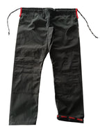 Black gi pants with red tabs on a white background