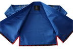 A blue competition gi with red lining on a white background