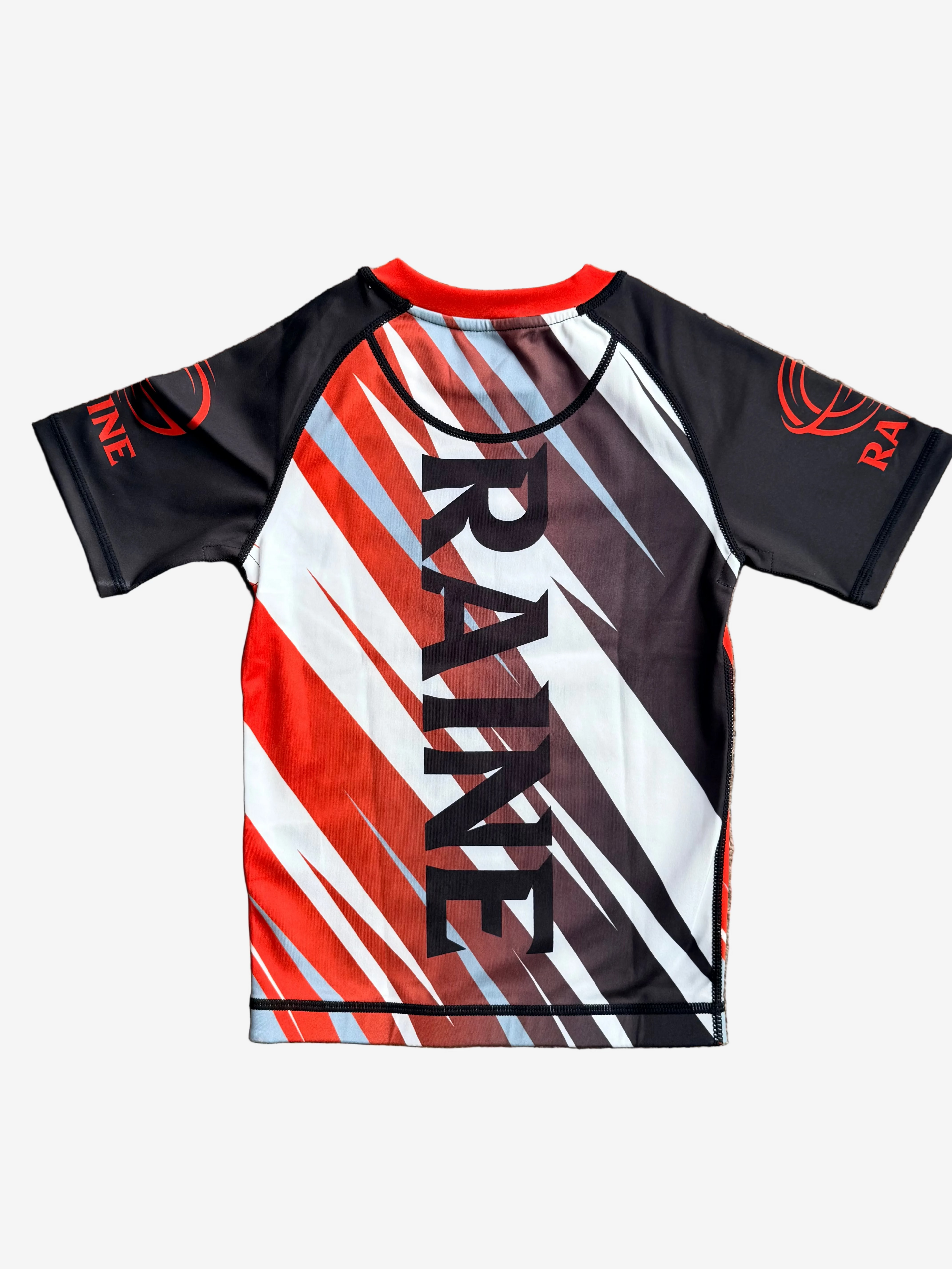 Short-sleeve rashguard with red, blacon a beige carpet