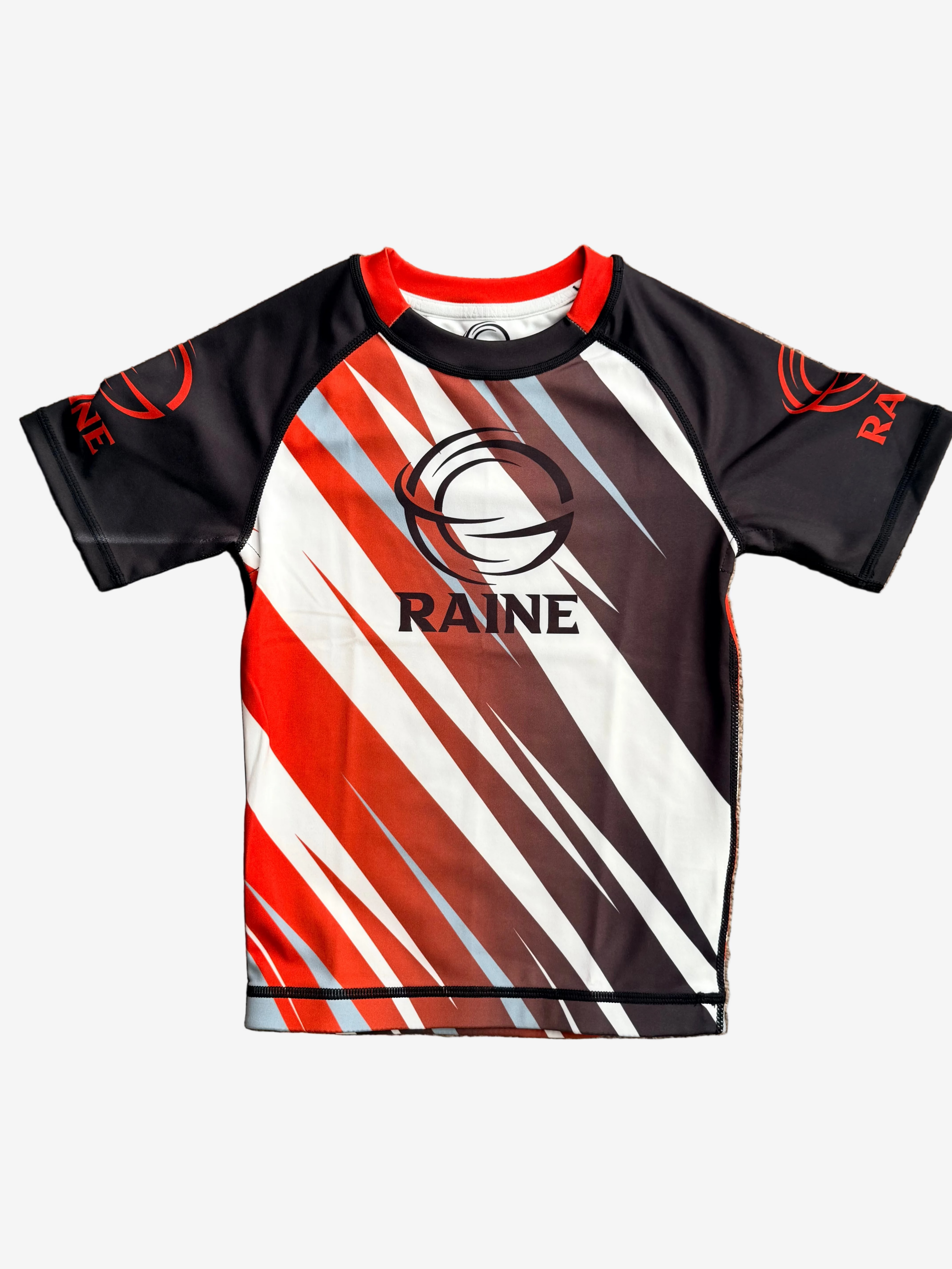 Raine rashguard with red, white, and black design 