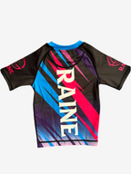 Colorful rashguard with 'RAINE' branding on a white background