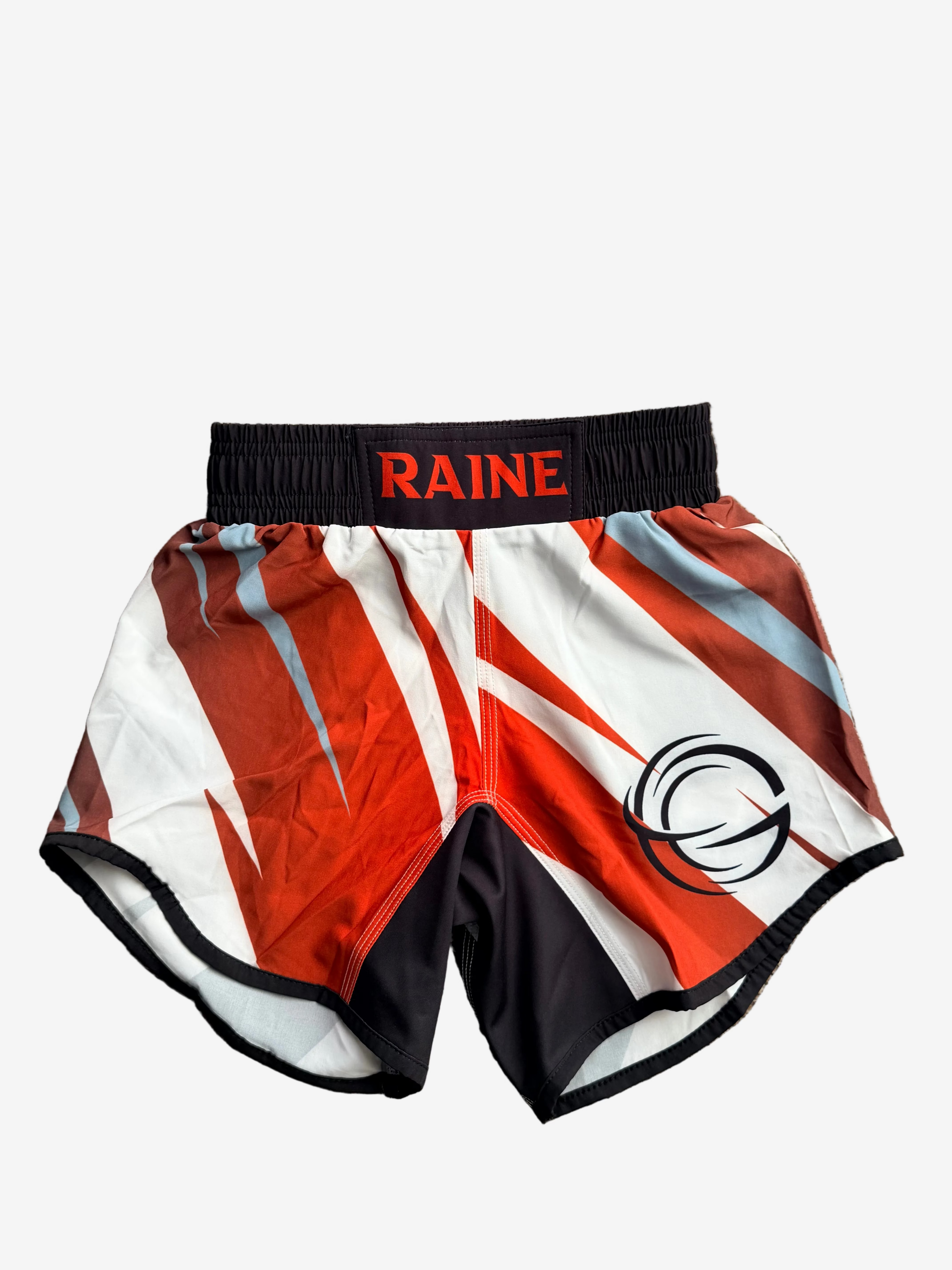 Red, white, and black athletic shorts with 'RAINE' branding 
