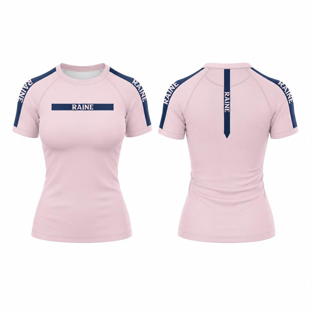Front and back views of a women's short-sleeve athletic top in light pink, featuring navy blue shoulder panels and vertical branding text 'RAINE' on the chest and back.