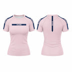 Front and back views of a women's short-sleeve athletic top in light pink, featuring navy blue shoulder panels and vertical branding text 'RAINE' on the chest and back.