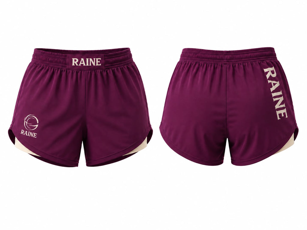 Front and back views of burgundy athletic shorts with 'RAINE' printed in white on the waistband and side, featuring a white circular logo on the front left leg and a white inner side hem.