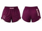 Front and back views of burgundy athletic shorts with 'RAINE' printed in white on the waistband and side, featuring a white circular logo on the front left leg and a white inner side hem.