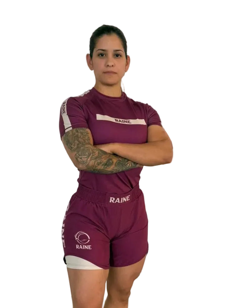 athlete wearing a burgundy nogi outfit with 'Raine' branding on a white background
