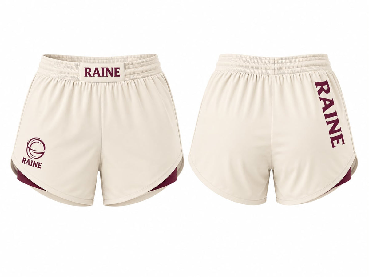 Front and back views of cream athletic shorts with maroon trim and 'RAINE' branding, displayed on a plain white background.
