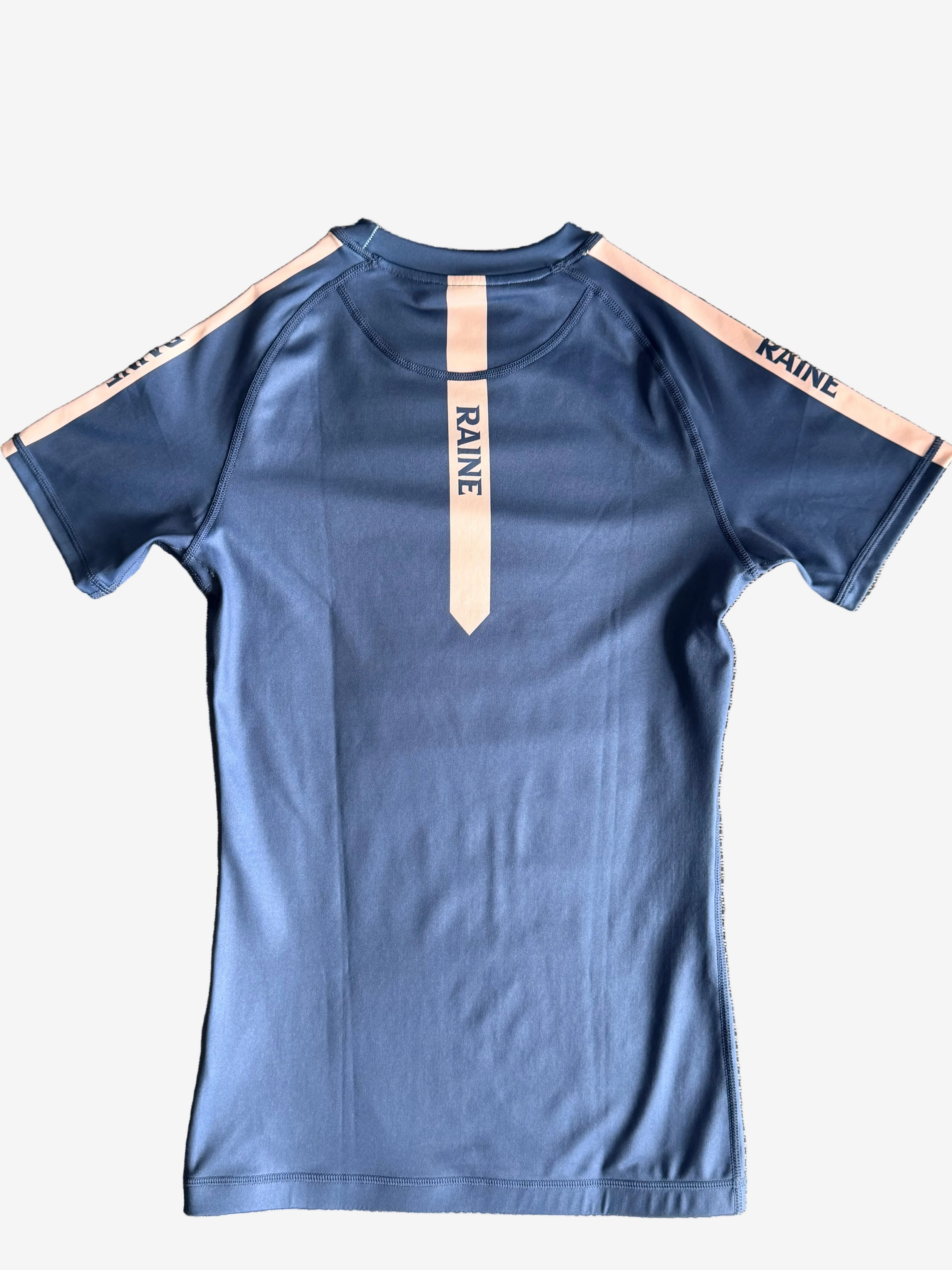 navy rashguard with 'RAINE' branding guard