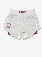 Ivory White athletic shorts with 'RAINE' branding on a brown textured surface
