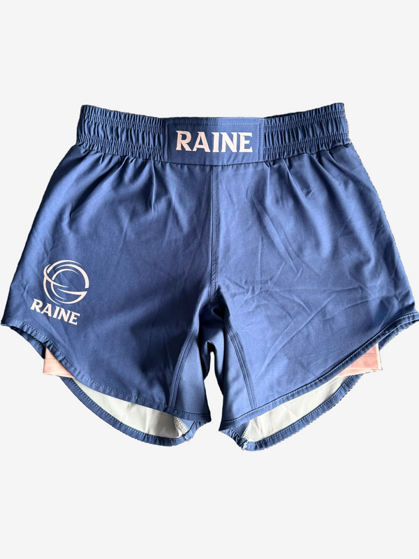 Blue athletic shorts with 'RAINE' branding on a textured surface