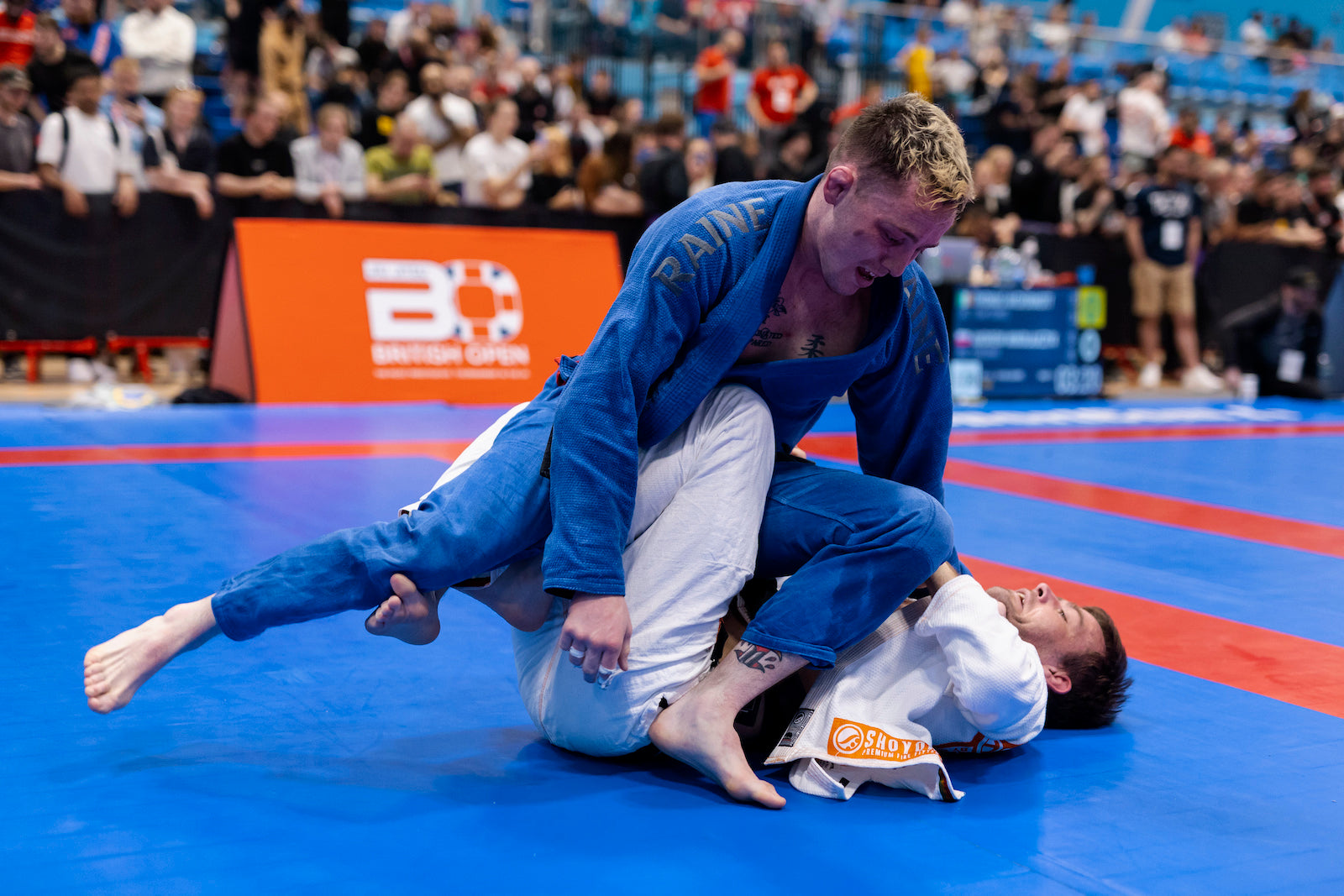 two jiu jitsu athletes competing in a gi competition